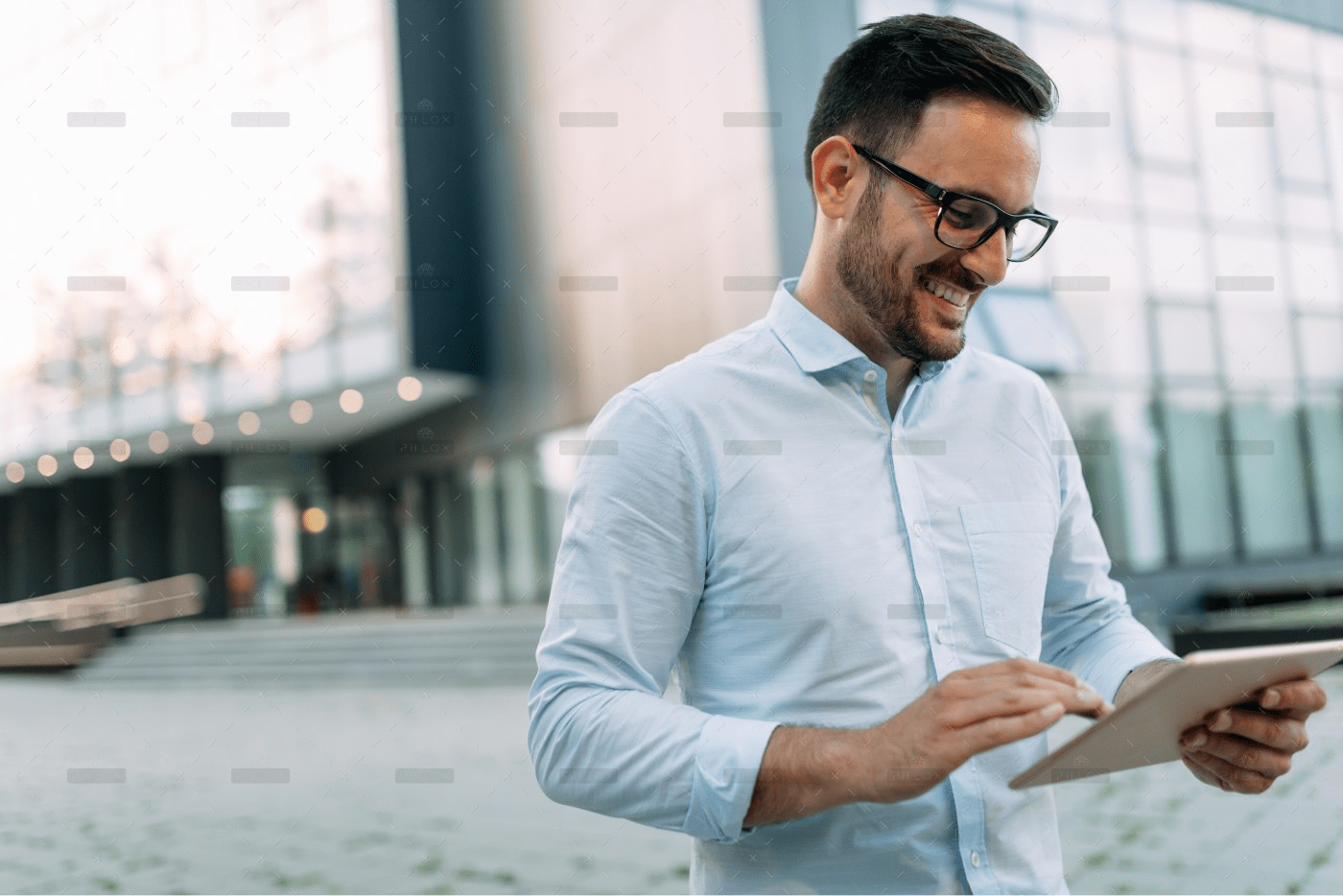 demo-attachment-1806-portrait-of-businessman-in-glasses-holding-tablet-AWVHCJU